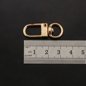 Detail view of 33mm gold zinc alloy lobster clasp with ruler showing precise size