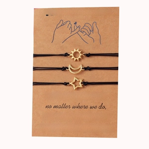 Detailed view of sun moon and star friendship bracelets with Pinky Promise card