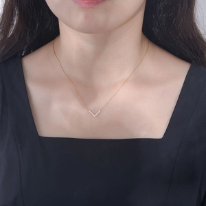 Elegant 925 sterling silver gold V-shaped necklace with crystals worn by a model