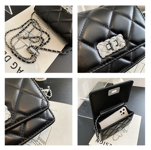 Detail showing black quilted bag interior space fitting a smartphone and silver lock