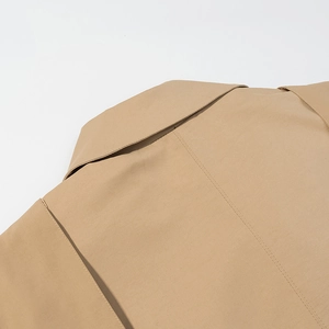Detailed close-up of khaki trench coat collar and shoulder seams with precise stitching