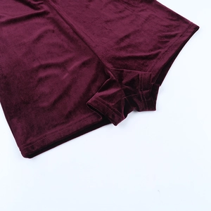 Close-up of wine red velvet fabric showing high-quality stitching and soft texture