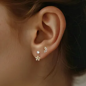 Close-up of S925 silver gold-plated star and moon flower stud earrings with zircons