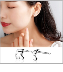 Macro detail of S999 silver musical note earrings with model wear and hallmarked posts