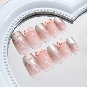 Pink leopard bow heart press-on nails with silver accents on heart mirror surface