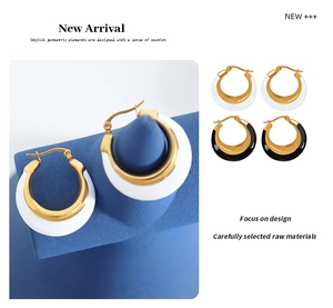 Detail of minimalist geometric hoop earrings in gold with black and white enamel finish