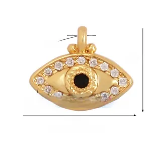 Macro view of gold-plated evil eye charm with white and black zircon stones