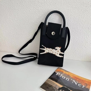 Detail view of mini black knitted phone bag featuring leopard cat pattern and metal buckle