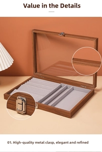 Detail of walnut wood jewelry box with glass lid, soft velvet lining and silver metal latch