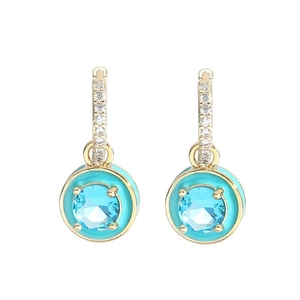 Close-up of gold plated earrings with turquoise round stone and pavé diamond accents