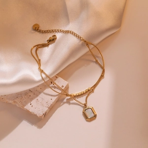 Double-layered gold titanium steel bracelet with snake chain and mother of pearl pendant