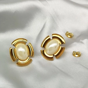Detail view of retro 18K gold plated twist borders and elegant pearls on satin