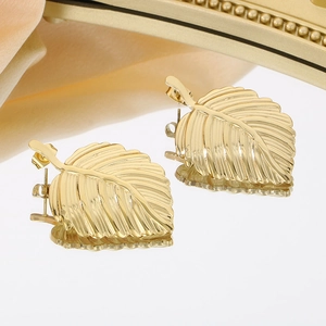 Elegant gold leaf-shaped stud earrings with realistic vein texture on reflective surface