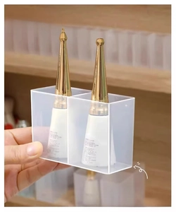 Macro shot of transparent two-compartment wall-mounted acrylic storage box for cosmetics