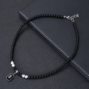 Close-up of 925 silver clasp on beaded necklace with black rectangle stone pendant