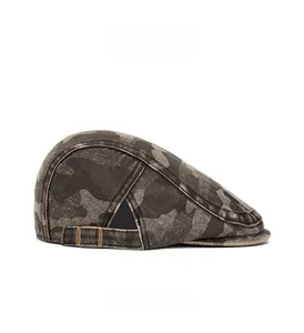 Close-up of vintage camo flat cap featuring washed canvas fabric and side metal buckle
