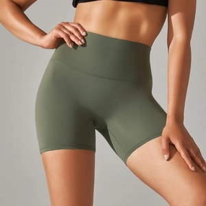 Detail of high-waisted olive green yoga shorts showing tummy control and fabric texture