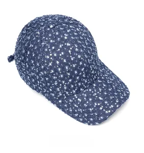 Close-up of distressed dark blue denim baseball cap with silver sequins and ripped detail