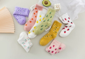Flat lay of soft mink velvet winter socks with colorful fruit patterns and cozy texture