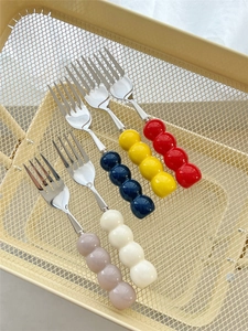 Detail of colorful ceramic bead handles on 304 stainless steel forks in a mesh basket