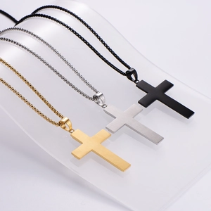 Detailed view of cross pendant necklaces in gold, silver, and black brushed metal