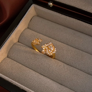 Macro shot of vintage golden rose snake ring with zircon inlay in a gray jewelry box