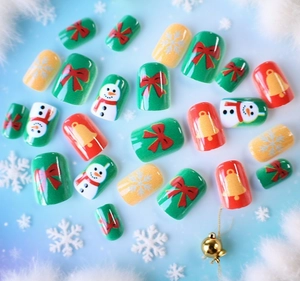 Detailed Christmas false nails featuring snowman, bells and snowflakes on blue background