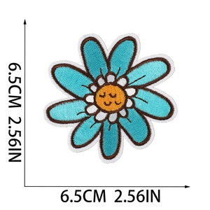 Detailed embroidery patch showing a blue daisy flower with a smiley face 6.5cm