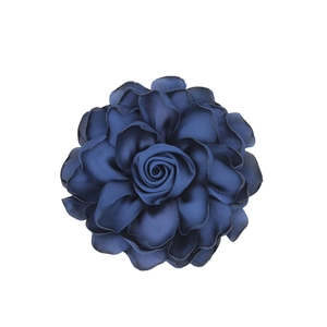 Detailed top view of a multilayered navy blue satin fabric flower with silky texture