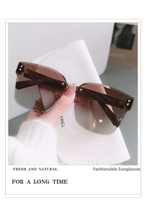 Detail of rimless gradient brown sunglasses with gold geometric patterned temples