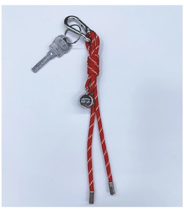 Close-up of red and white woven nylon lanyard keychain with silver metal ball pendant