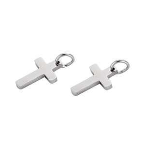 Macro shot of silver stainless steel cross pendants with polished metal rings