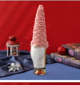 Detail of pink gnome wine bottle cover with faux fur beard and knit hat for Christmas