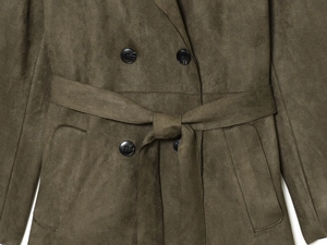 Detail of olive green faux suede coat featuring double-breasted buttons and waist belt
