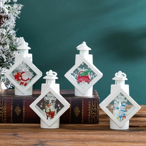White LED Christmas lanterns with Santa and Reindeer on vintage books tabletop display