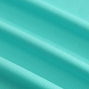 Macro shot of breathable mint green mesh fabric showing detailed texture for a polo shirt
