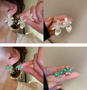 Detail of floral pearl earrings and green butterfly studs with rhinestones on model