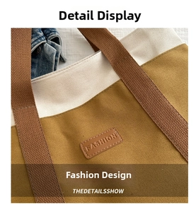 Detailed macro view of canvas tote bag with brown leather FASHION patch and sturdy strap