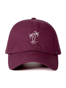 Close-up of white palm tree embroidery on a dark burgundy cotton baseball cap