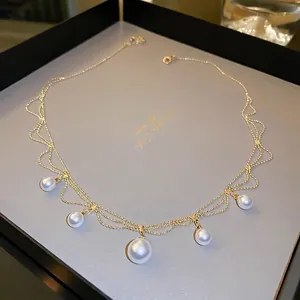 Elegant gold-plated wave layered necklace with five gradient pearls in a luxury gift box