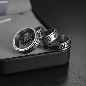Stress relief spinner rings set in stainless steel with wave and flower patterns