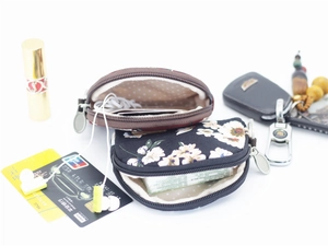 Close-up of small floral canvas coin purses with metal zippers and dot print lining