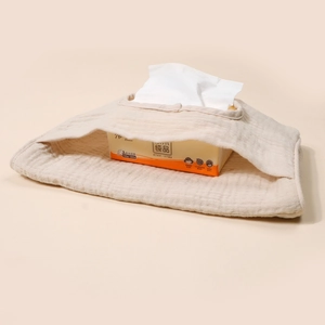 Detail of beige quilted cotton crib organizer showing soft texture and premium piping edge