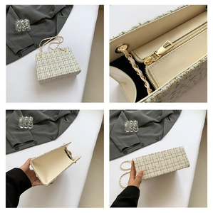 Detail of the gold zipper and chain strap on a white tweed plaid crossbody bag