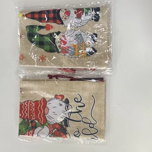 Detail view of festive Christmas drawstring gift bags with gnome and santa prints in packaging
