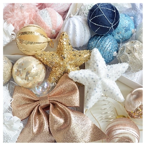 Detail of glitter bows and assorted ornaments in a festive Christmas decoration gift set