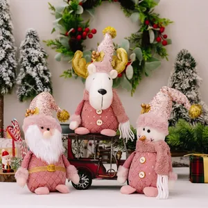 Detailed view of pink sequined Santa, reindeer and snowman plush holiday decorations