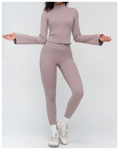 Detail of high-waist yoga leggings with side pockets and slim-fit stand collar jacket
