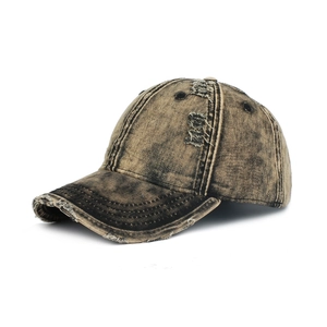 Detail view of distressed edges and ripped holes on vintage canvas baseball cap