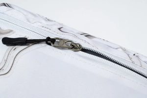 Close-up of metal zipper and marble print fabric on lightweight outdoor waist bag